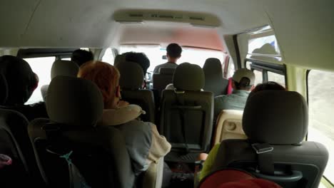 Close-up-of-many-people-seated-inside-a-mini-bus-traveling