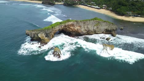 Drone-view-of-coral-rock-crushing-by-the-wave-on-the-tropical-beach