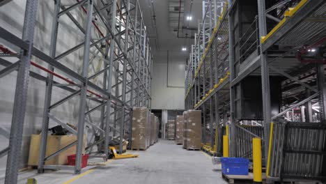 Cardboard-parcels-ready-for-shipment-in-vast-warehouse,-online-shopping-concept