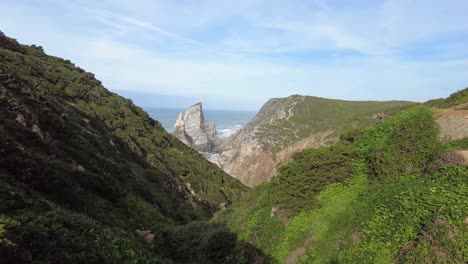 Woman-hiking-to-Praia-da-Ursa-beach-and-cliffs