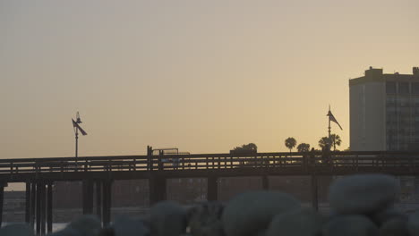 Time-lapse-shot-of-people-walking-across-the-Ventura-Pier-at-sunset-located-in-Ventura-County-Southern-California