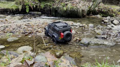Remote-controlled-Off-Road-car-driving-through-a-riverbed