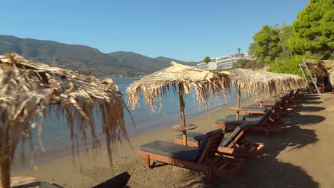 Sunbeds-with-Dried-Grass-in-Paralia-Mikro-Neorio-with-Blue-Colour-Water-Bay