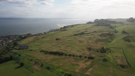 Aerial-Shot-of-Kinghorn-Golf-Course-in-Fife-Panning-View-of-Whole-Course-and-Firth-Of-Fourth