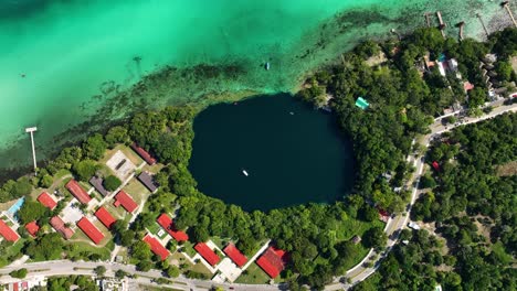 Aerial-view-above-the-cenote-Negro-in-the-Bacalar-town,-sunny-Mexico---top-down,-drone-shot