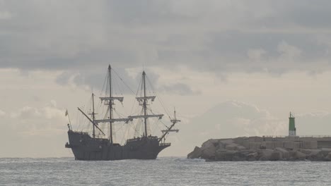 16th-Century-Galleon-Andalucia-replica-ship-arriving-at-port-in-a-beautiful-cloudy-day-at-sunrise