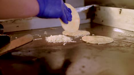 Female cook placing handmade tortillas on a big comal Stock Video Footage  by ©KanelBulle #456050806