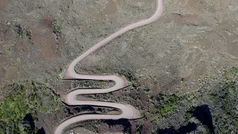 A-fly-over-the-volcano-road-in-Reunion-Island,-France---Plaine-des-sables,-UNESCO