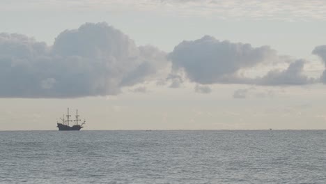 16th-Century-Galleon-Andalucia-replica-ship-sailing-in-the-distance-in-the-Mediterranean-sea-in-a-beautiful-cloudy-day-at-sunrise