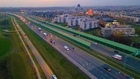 Hyperlapse-or-Dronelapse-Aerial-view-of-Highway-road-next-to-City-Warsaw,-Wilanow