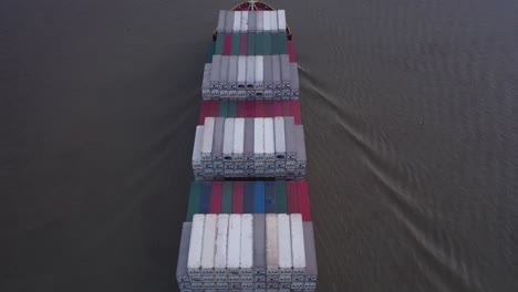 Aerial-fly-over-heavily-laden-container-ship-navigating-on-the-calm-sea