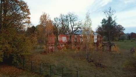 Aerial-View-of-the-Ruins-of-an-Ancient-Manor-in-Golden-Autumn