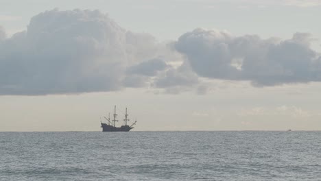 Timelapse---16th-Century-Galleon-Andalucia-replica-ship-anchored-in-the-distance-in-the-Mediterranean-sea-in-a-cloudy-day-at-sunrise