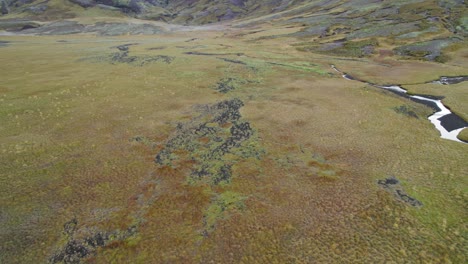 Birds-Eye-View-Of-Open-Icelandic-Outback-Landscape-Valley-Covered-In-Moss-With-Beautiful-River-Running-Through-It