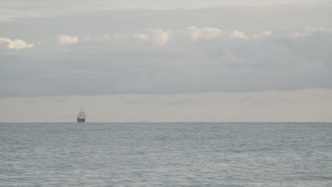 16th-Century-Galleon-Andalucia-replica-ship-sailing-in-the-distance-in-the-Mediterranean-sea-in-a-beautiful-cloudy-day-at-sunrise