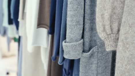 Close-up-of-several-new-winter-garments-hanging-on-a-coat-rack