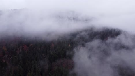 Aerial-view-of-mountain-moving-clouds-during-autumn-fall-in-Vosges,-France,-4K