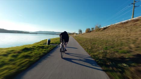 FPV-following-Jake-the-Fixedgear-Biker-next-to-Danube-River-during-sunny-autumn-day