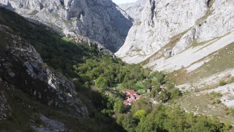 sweet-tiny-mountain-village-called-Bulnes-in-Asturias-in-Spain,-Drone-and-sun