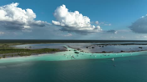 Aerial-view-approaching-yachts-at-the-Pirates-channel,-in-the-Laguna-Bacalar,-sunny-Mexico