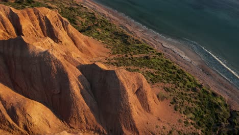 Sellicks-Beach-aerial-reveal-of-ocean-and-cliffs-at-sunset-golden-hour,-Fleurieu-Peninsula,-South-Australia