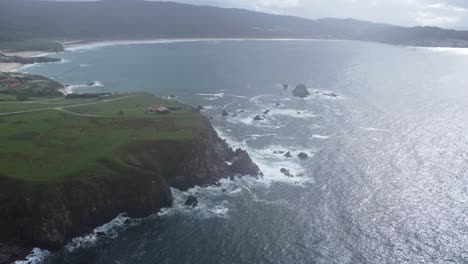 Cliff-in-front-of-lanzada-beach-in-galicia-in-north-spain-on-the-atlantic-ocean-filmed-with-a-drone