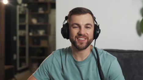 Ein-Junger-Mann-Mit-Kopfhörern-Grüßt-Und-Spricht-über-Einen-Videoanruf