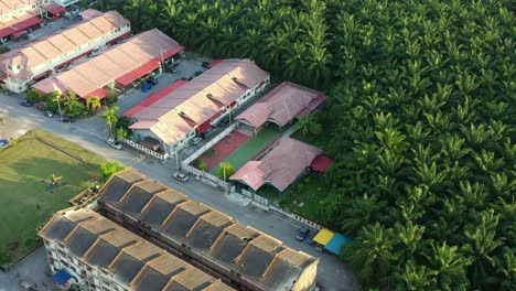 Birds-eye-view-aerial-flyover-residential-kampung-china-neighborhood,-Seri-Manjung,-Sitiawan,-hectares-of-palm-tree-commercial-business-plantations,-Malaysia-rank-top-among-global-market-suppliers