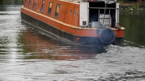 Close-up-narrow-houseboat-turning-at-canal-waters-in-London,-United-Kingdom