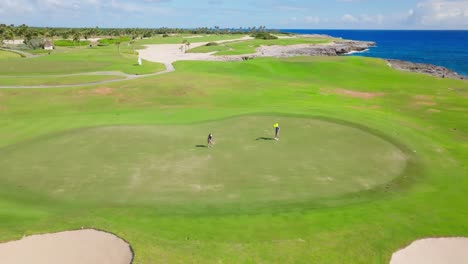 Tourists-Playing-Golf-In-Los-Corales-Golf-Course-In-Punta-Cana,-Dominican-Republic---aerial-drone-shot