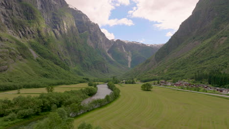 Scenic-Gudvangen-valley-with-tall-mountain-cliffs-in-Norway,-aerial