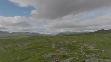 Hardangervidda-mountain-plateau-national-park-with-grass-and-rocky-surface,-aerial