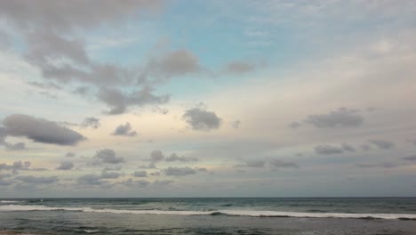 Stabile-Aufnahme-Des-Ozeanhintergrunds,-Strahlend-Blauer-Himmel-Mit-Weißen-Wolken-Und-Wellen-Auf-Offener-See,-Die-Sich-Dem-Horizont-Nähert