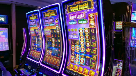Cruise-ship-casino-full-of-slot-machines-with-flashing-lights-and-jackpot