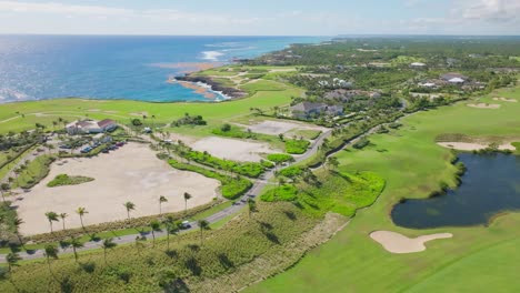 Drone-shot-of-beautiful-Golf-Court-and-natural-Lake-near-coastline-of-Punta-Cana-during-summer