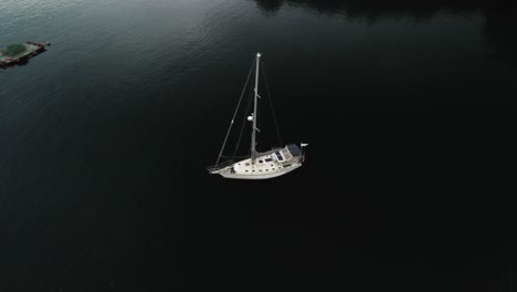 Aerial-orbit-shot-of-a-white-yacht