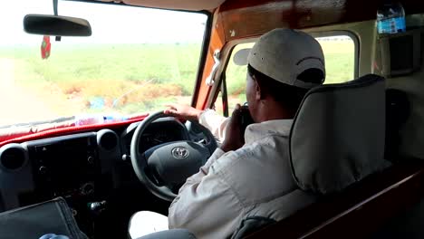 View-inside-a-safari-car-with-the-guide-driving-and-talking-on-the-radio