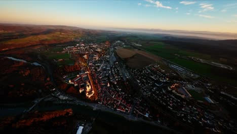 Smooth-slow-rotating-aerial-shot-of-the-cozy-city-of-Melk-during-late-fall-sunset