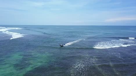Drone-shot-of-Fishing-boats-speed-over-the-sea-towards-the-beach