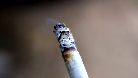 Close-up-shot-of-burning-filter-cigarette,-health-risk-concept