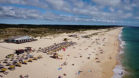 Comporta-Beach-and-Comporta-CafÃ©-on-the-Portugal-coast-on-a-Blue-sky-with-clouds-and-blue-ocean