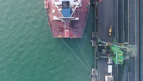 Aerial-top-down-shot-of-Large-Coal-Ship-docked-in-port,-Queensland-Australia