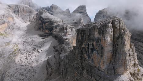 Spectacular-rock-formation-of-Brenta-Mountains-during-cloudy-day-at-sky-in-Italy---drone-flight