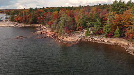 Peaceful-aerial-shot-of-a-lake-in-Killbear-Provincial-Park-in-the-fall