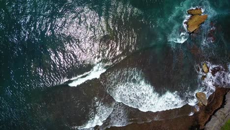 Blick-Von-Oben-Auf-Die-Wellen-Des-Indischen-Ozeans,-Die-Mit-Sonnenreflexion-über-Dem-Korallenriff-Brechen
