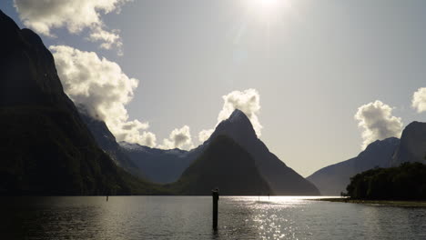 Fiords-of-Milford-Sound-with-reflective-lake-water,-shot-from-harbor