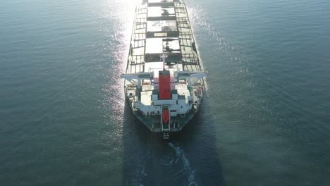 Aerial-shot-of-Large-Coal-Ship-Leaving-Port,-Gladstone-Queensland-Australia