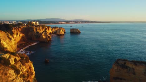 Aerial-jib-up-revealing-amazing-cliff-sides-painted-with-Golden-Hour-sun