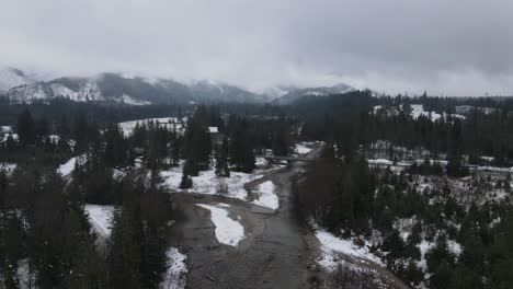 4K-moody-drone-shot-of-river-in-mountains,-Tatra-Mountains,-Poland