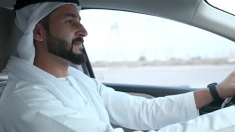 Driving-Arab-Emirati-while-hands-on-car-steering-wheels